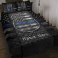 Police quilt blanket displayed on a bed with badge artwork, stars, and a black and blue thin line design
