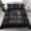 Police badge quilt blanket styled on a bedroom bed with black, gray, blue, and star artwork
