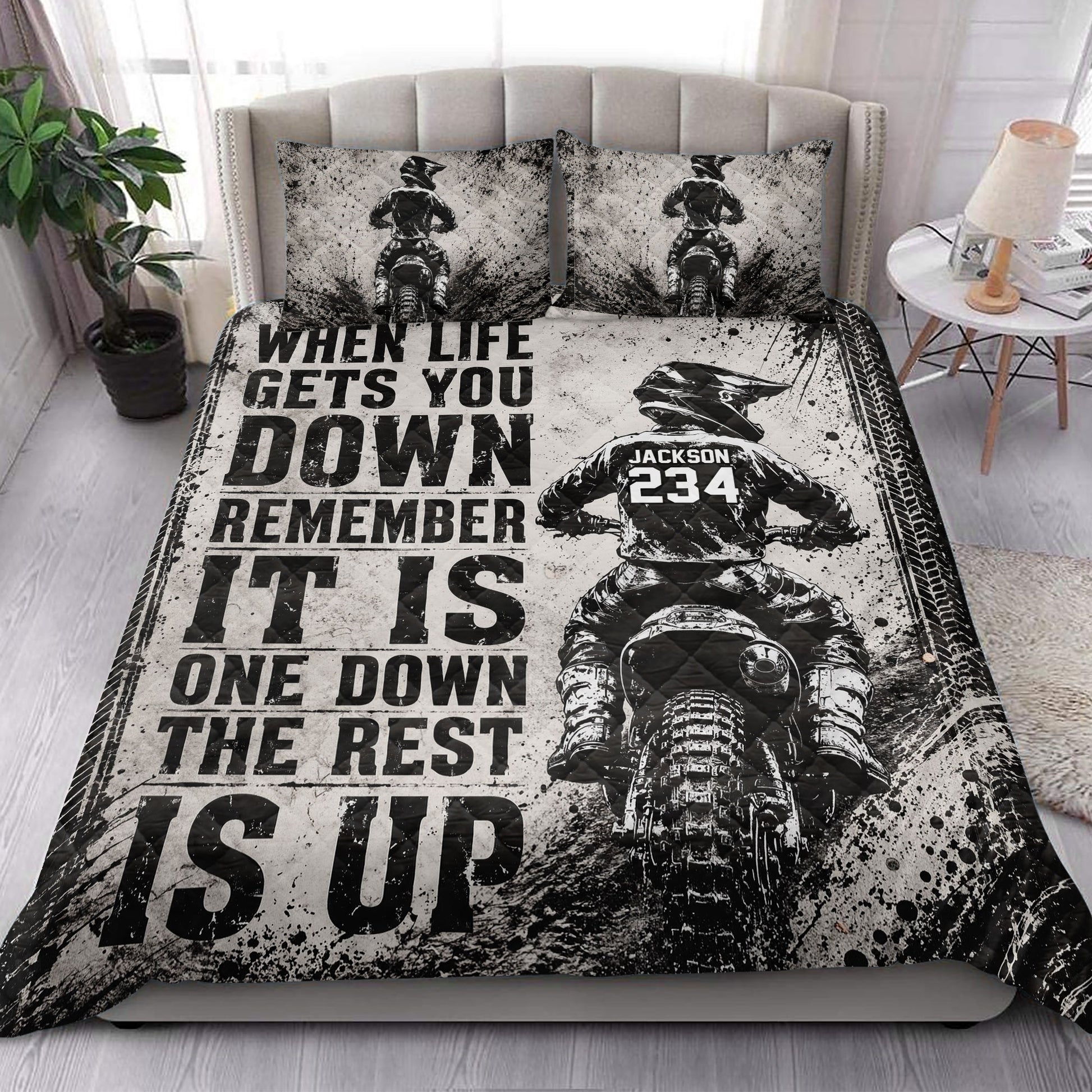 Motocross quilt blanket styled in a bedroom with dirt bike rider artwork and dramatic black and white graphics