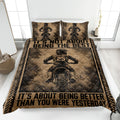 Motocross quilt blanket displayed on a bed with dirt bike riders, tire-track borders, and rugged sepia artwork