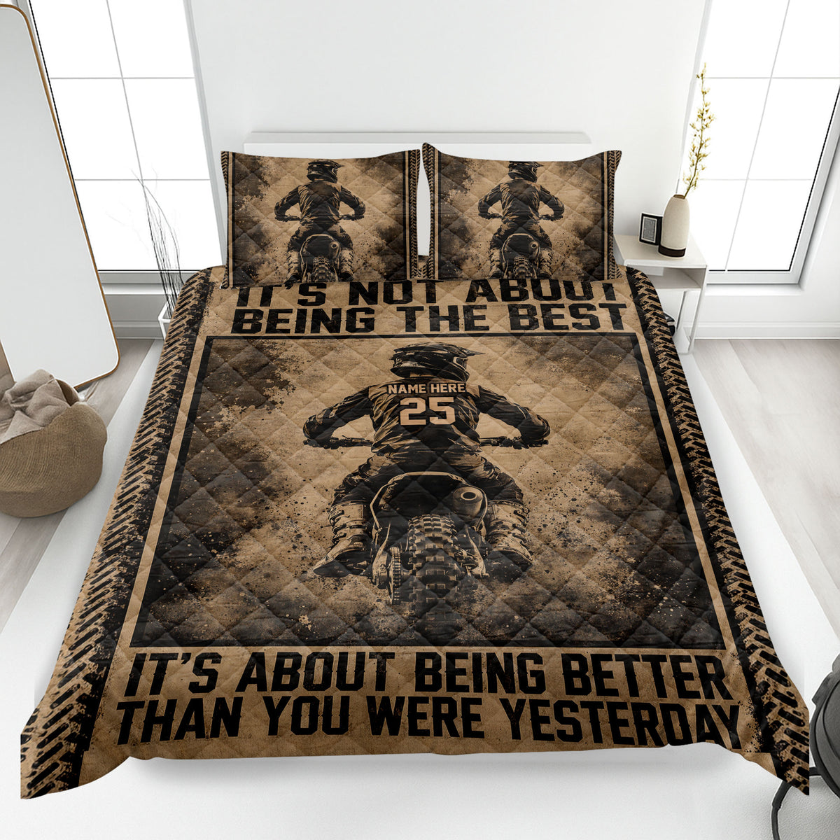 Motocross quilt blanket displayed on a bed with dirt bike riders, tire-track borders, and rugged sepia artwork