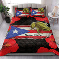 Puerto Rico coqui frog quilt blanket styled across a bedroom with tropical red flowers and flag-inspired artwork