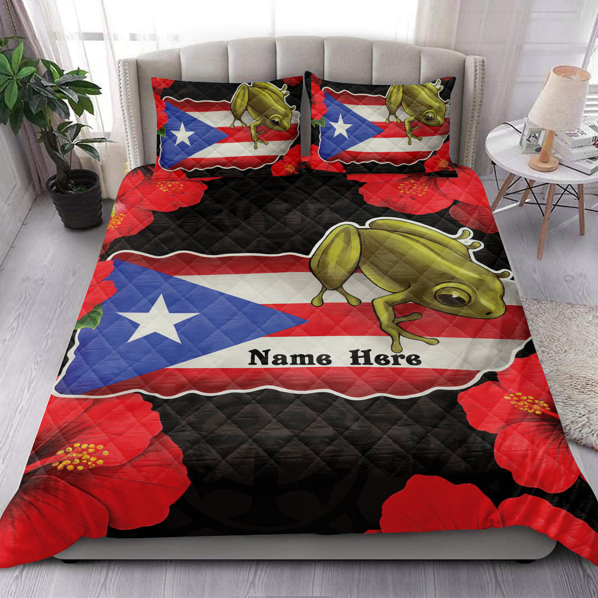 Puerto Rico coqui frog quilt blanket styled across a bedroom with tropical red flowers and flag-inspired artwork