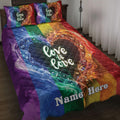 Rainbow LGBT quilt blanket bedding set with colorful heart artwork and an inclusive love message in a bedroom