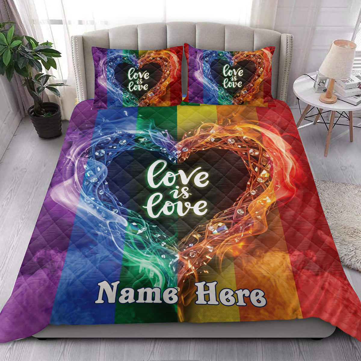 Rainbow Pride quilt blanket styled on a modern bed with colorful heart artwork and inclusive bedroom decor