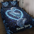 Dolphin quilt blanket displayed on a bed with glowing blue hearts, stars, and floral border artwork