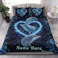Dolphin quilt blanket styled in a bright bedroom with ocean-inspired blue artwork