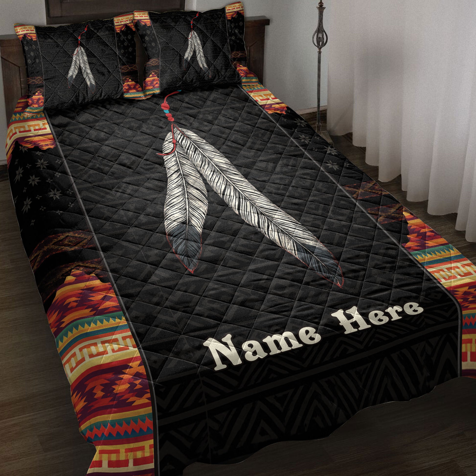 American Native-inspired quilt blanket on a bed with feather artwork and colorful geometric border patterns
