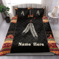 American Native-inspired quilt bedding set styled in a bedroom with black feather artwork and colorful borders