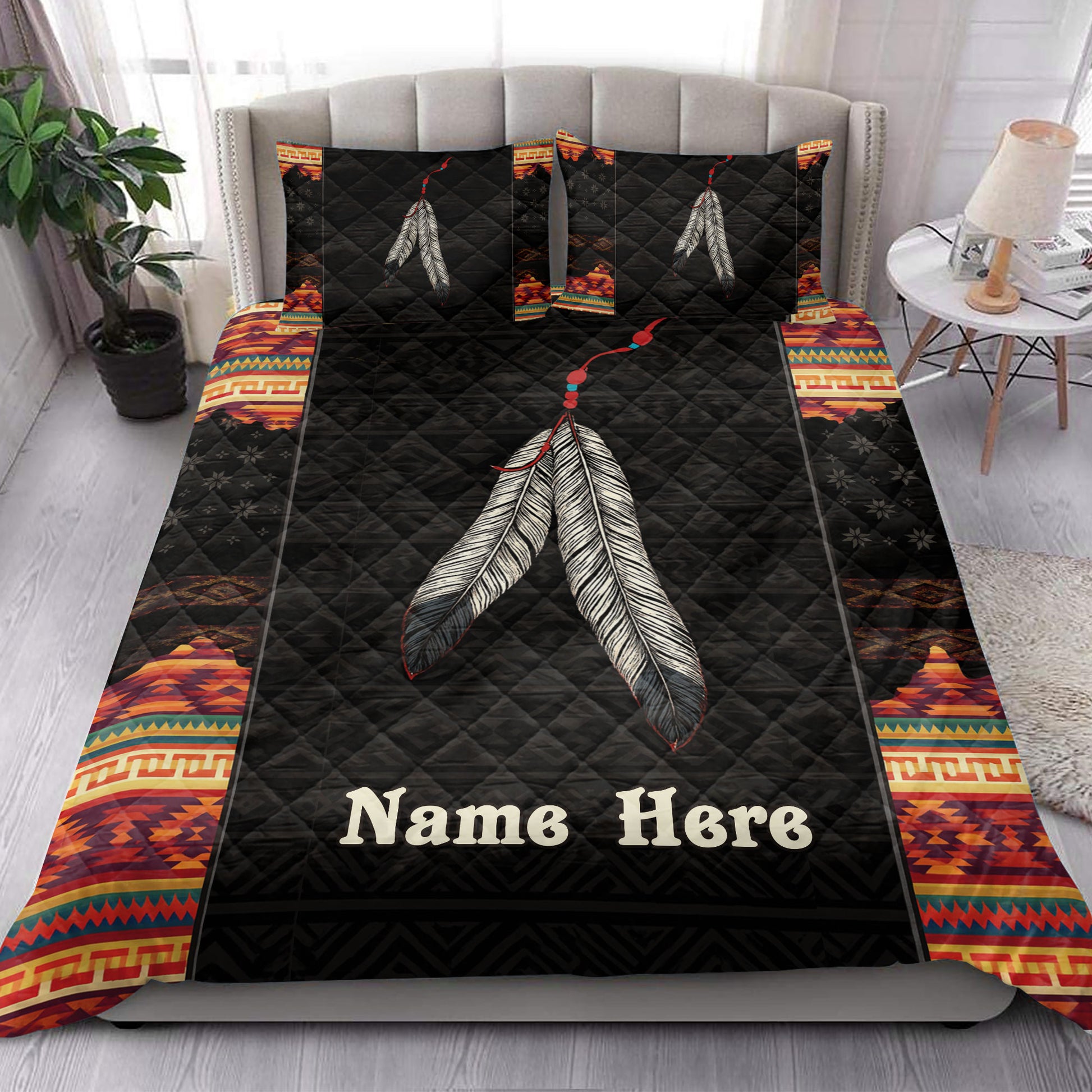 American Native-inspired quilt bedding set styled in a bedroom with black feather artwork and colorful borders