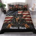 Patriotic Rottweiler quilt blanket styled on a bedroom bed with matching flag-themed dog pillows