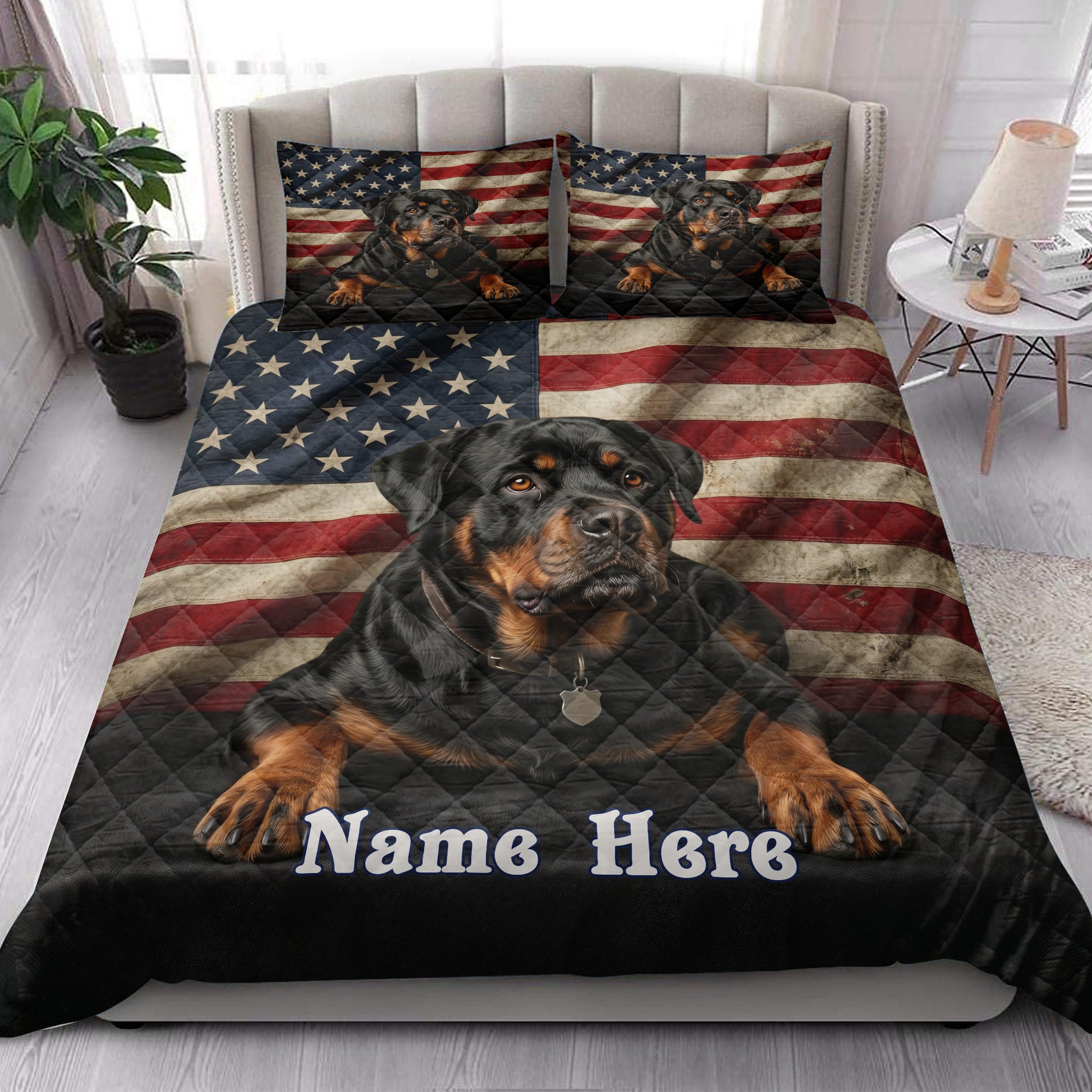 Patriotic Rottweiler quilt blanket styled on a bedroom bed with matching flag-themed dog pillows