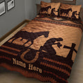 Angled bedroom view of a cowboy quilt blanket featuring horses, western patterns, horseshoes, and brown tones