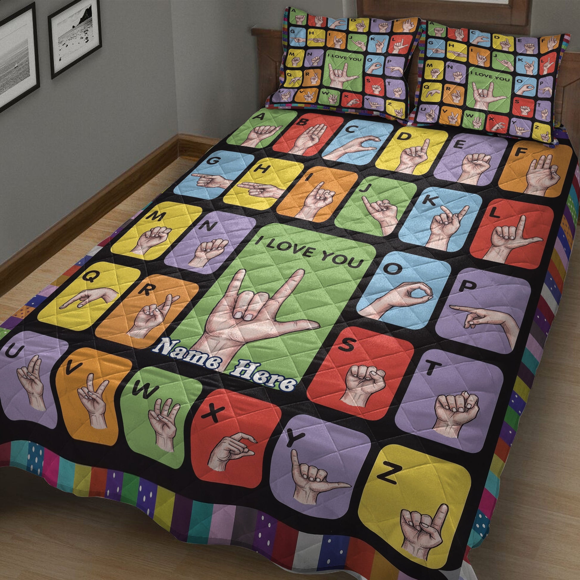 Close bedroom view of a colorful sign language alphabet quilt with hand gesture illustrations