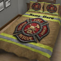 Close bedroom view of firefighter quilt with red rescue emblem, helmet and tools, and high-visibility stripes