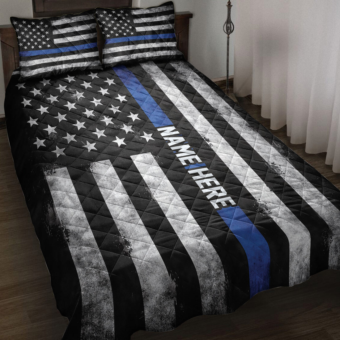 Police quilt blanket on a bed with Thin Blue Line stripes, stars, and bold black and white patriotic artwork