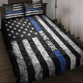 Police quilt blanket on a bed with Thin Blue Line stripes, stars, and bold black and white patriotic artwork