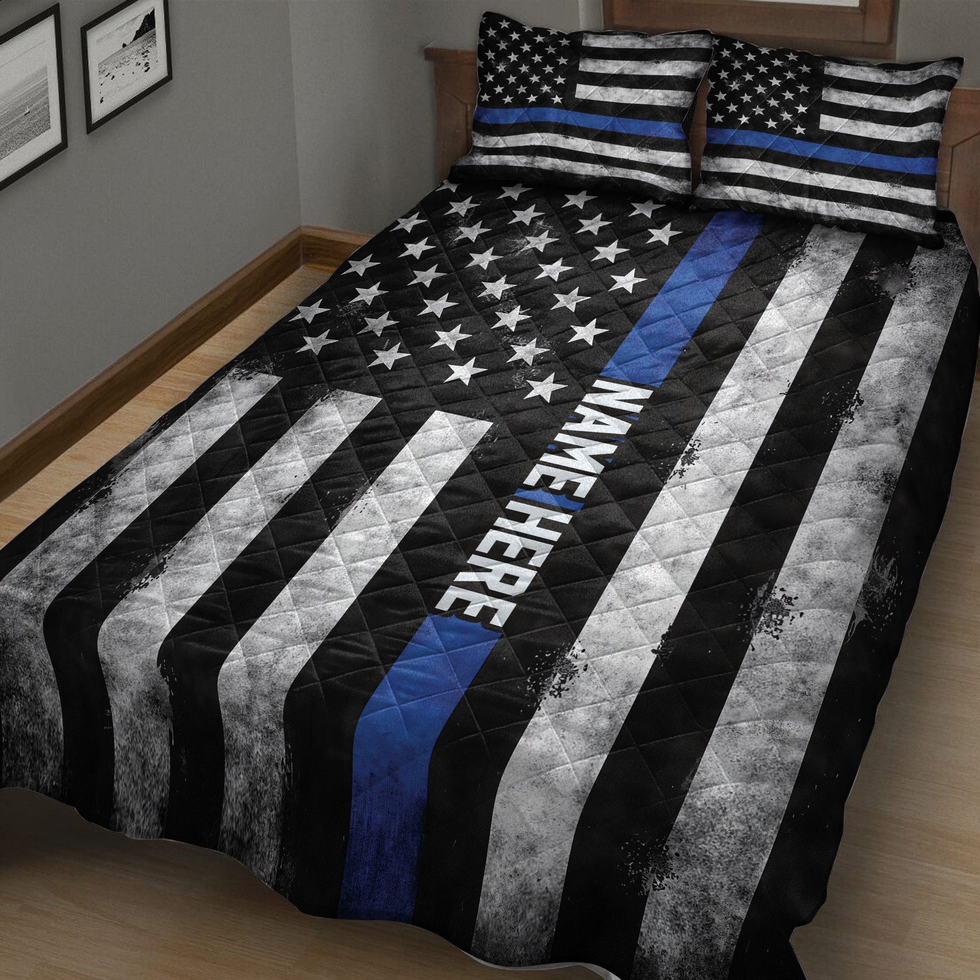 Black and white police quilt blanket with blue stripe and star pattern presented on a bedroom bed