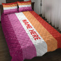 Lesbian pride quilt blanket bedding set styled on a bedroom with bold pink, white, orange, and red stripes