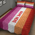 Close bedroom view of a lesbian pride quilt blanket with bold striped artwork and quilted texture