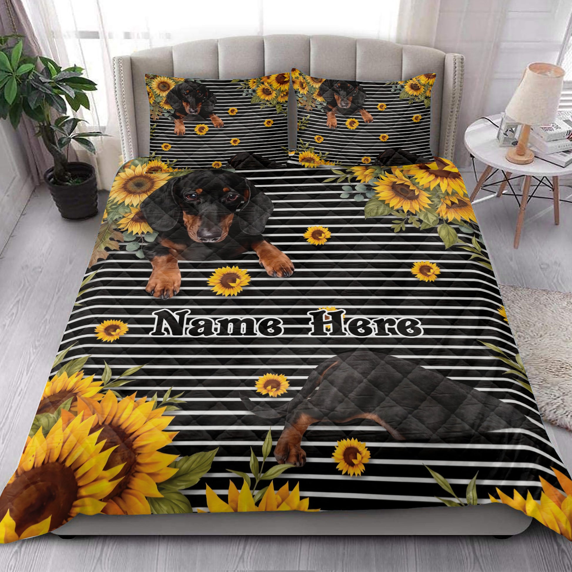 Dachshund quilt bedding styled on a bed with sunflowers, black stripes, and coordinating pillowcases