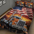 Close view of a trucker quilt blanket featuring a large orange semi truck, mountain scenery, and flag stripes
