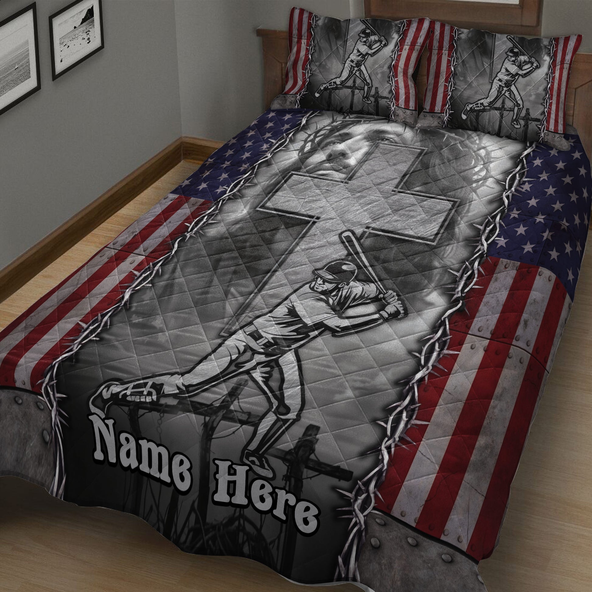 Angled bedroom view of a baseball quilt blanket with batter artwork, stars and stripes, and bold monochrome design