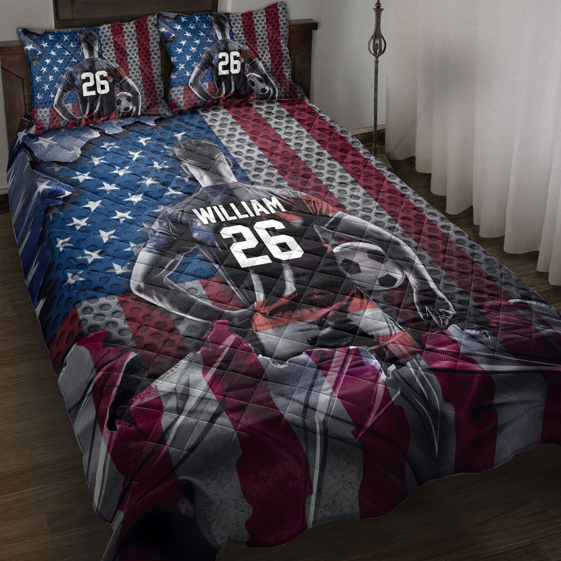 Soccer quilt blanket displayed on a bed with player artwork, soccer balls, and red, white, and blue stripes