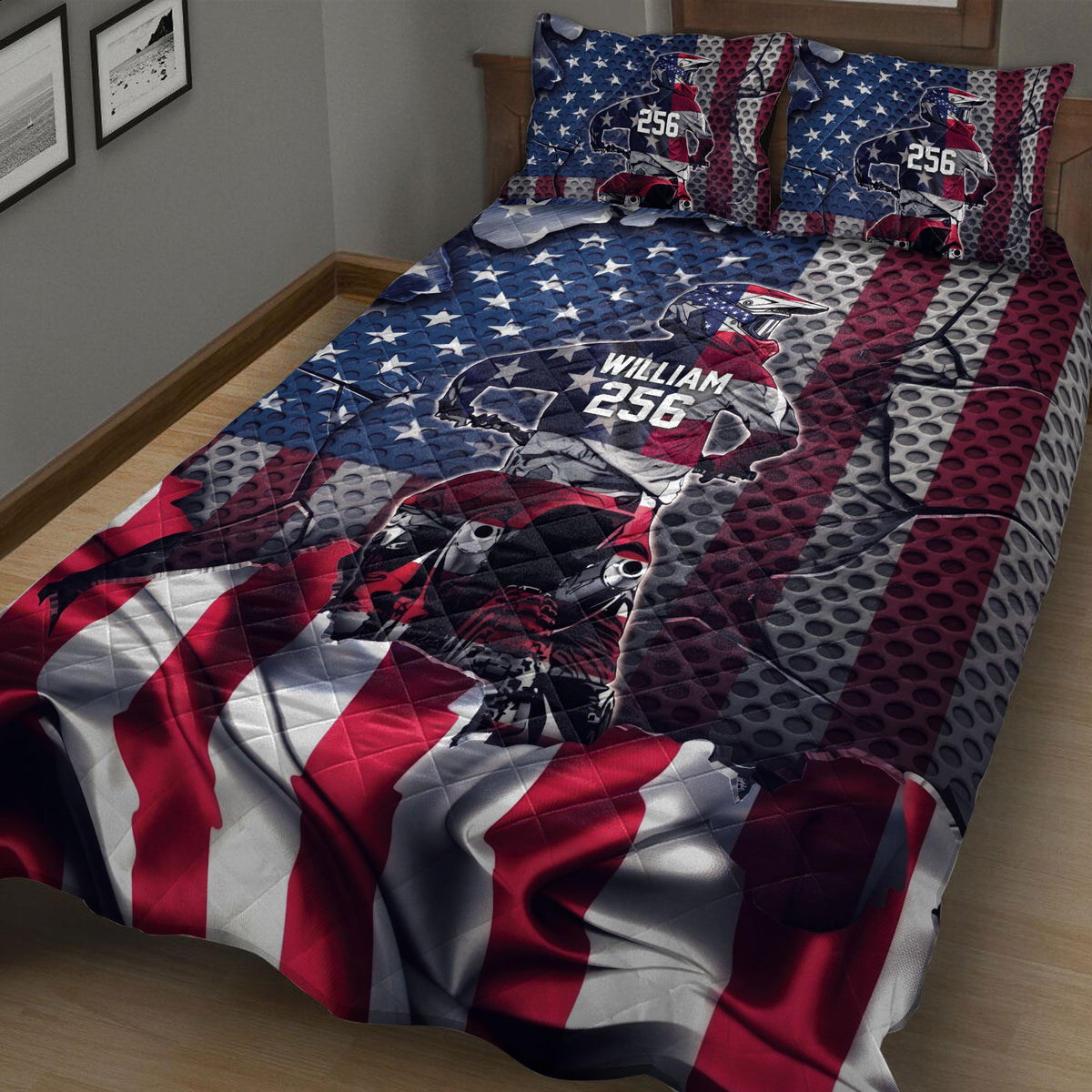 Motocross quilt blanket shown on a bed with bold dirt bike rider artwork and red, white, and blue graphic panels