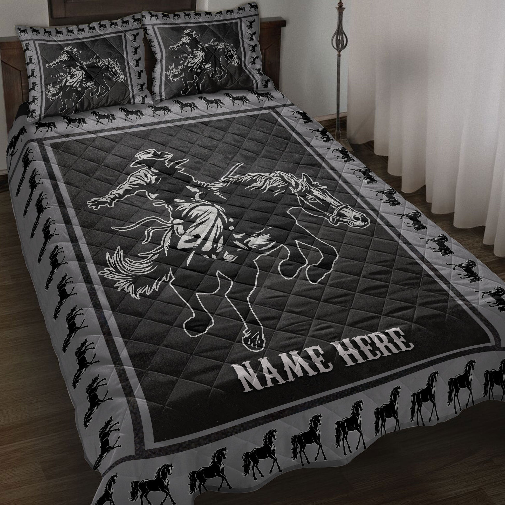 Black and gray rodeo quilt blanket displayed on a bed with cowboy and bucking horse artwork