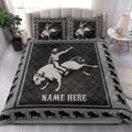 Rodeo quilt bedding styled on a bed with dramatic bucking bull and cowboy western artwork