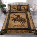 Western rodeo quilt blanket styled on a bed with cowboy and bucking horse artwork