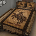 Close view of rodeo cowboy and bucking horse artwork on a rustic Western quilt