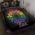 LGBTQ pride quilt blanket with a vibrant rainbow sunflower design on a black ornate background