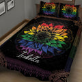 Angled bedroom view of a black LGBTQ pride quilt with colorful rainbow sunflower artwork