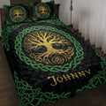 Tree of Life quilt blanket displayed on a bed with golden artwork, green Celtic knotwork, and black detailing