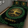 Close bedroom view of a black Tree of Life quilt blanket with golden branches and vivid green knotwork