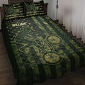 BMX rider and bicycle artwork on a dark green and gold quilt blanket in a bedroom