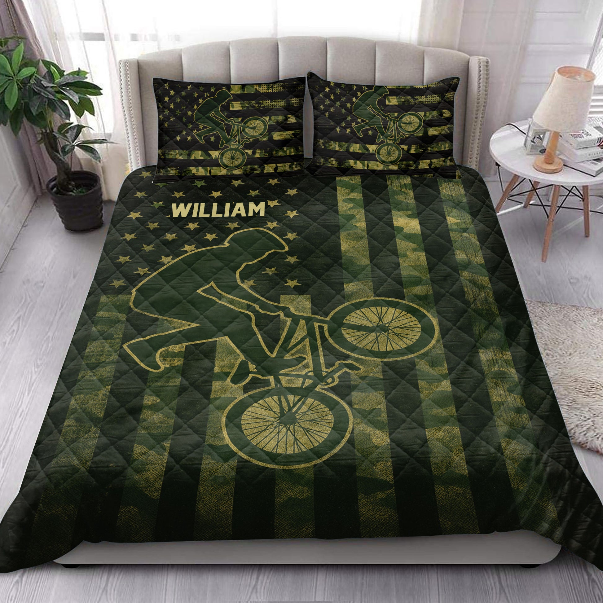 BMX quilt blanket styled on a bed with rider silhouettes, bicycles, stars and green stripes