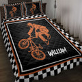 BMX quilt blanket on a bed with orange freestyle rider artwork and black and white checkerboard border