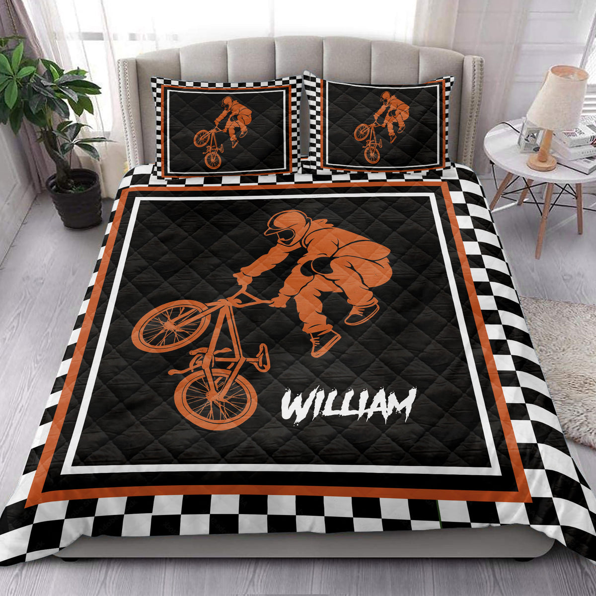 BMX quilt blanket styled in a bedroom with freestyle cycling artwork and orange black decor