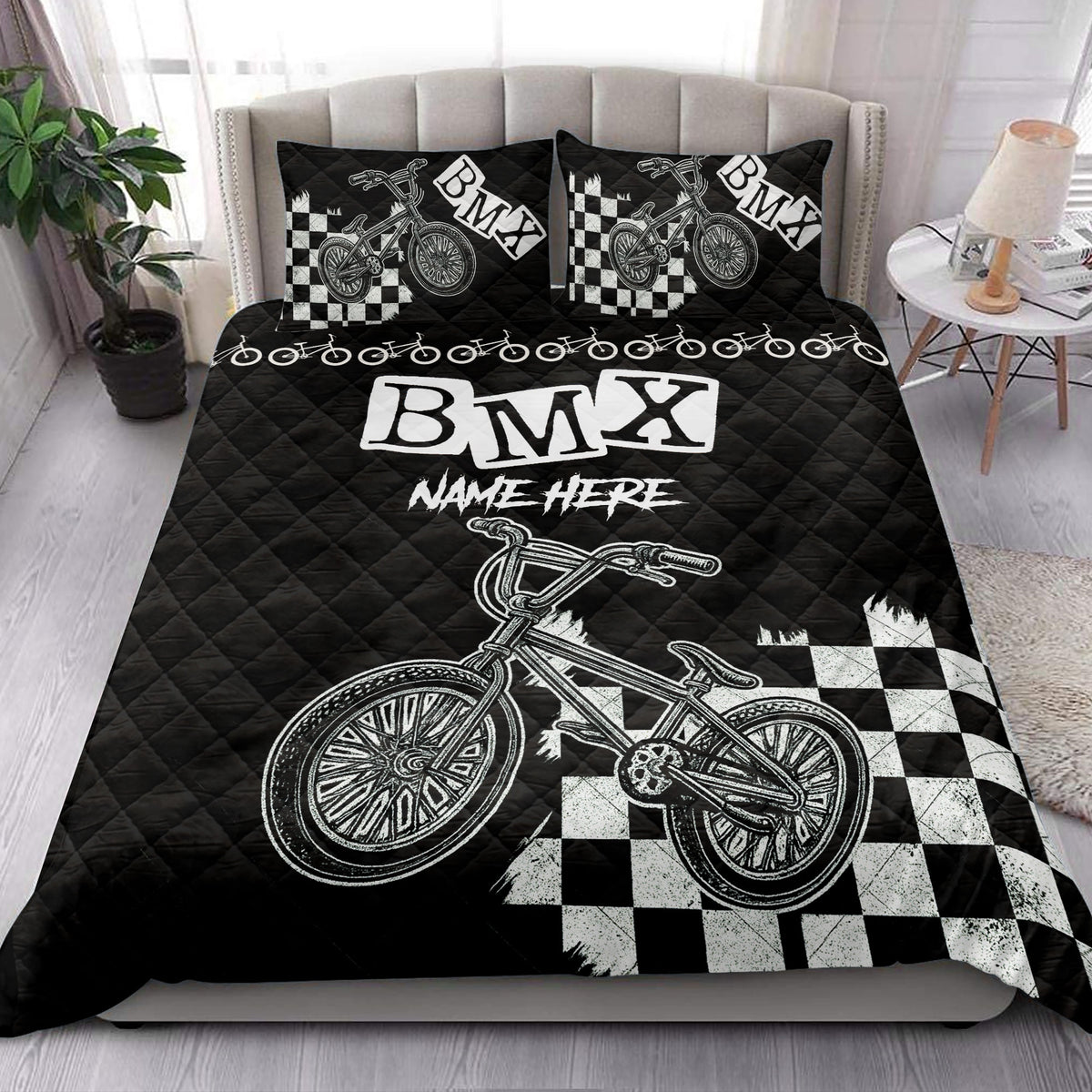 BMX quilt blanket styled on a bed with bold bicycle artwork and checkerboard accents