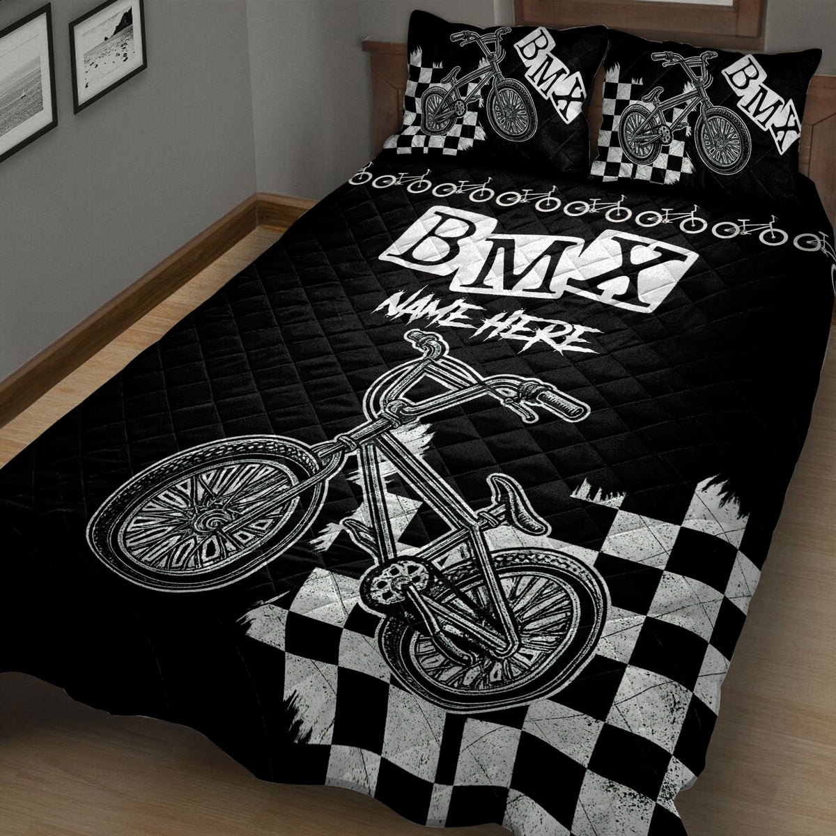 Close bedroom view of black BMX quilt blanket with bicycle graphics and checkerboard design