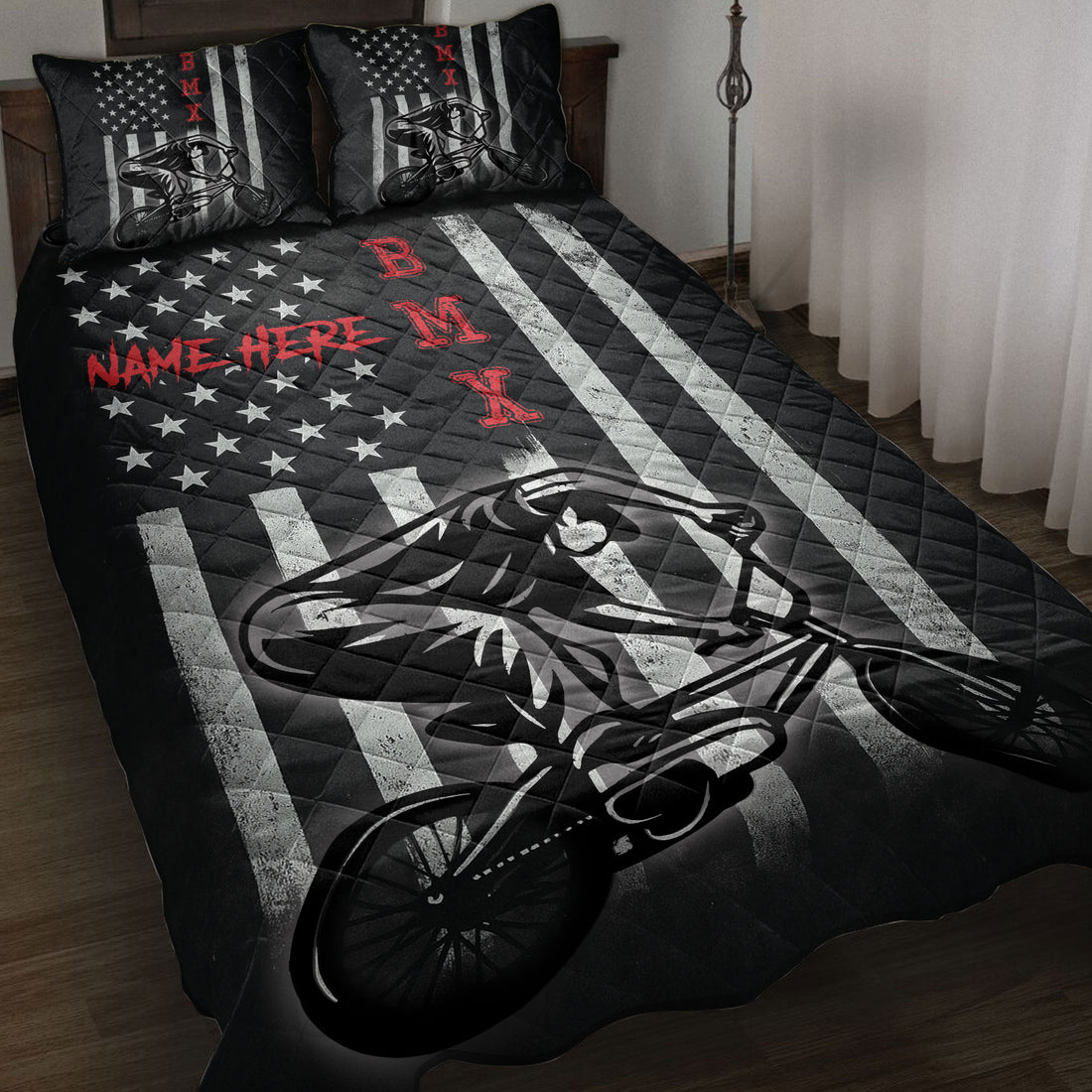 BMX quilt blanket displayed on a bed with bold black, white, red, star, and BMX rider artwork