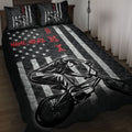 BMX quilt blanket displayed on a bed with bold black, white, red, star, and BMX rider artwork