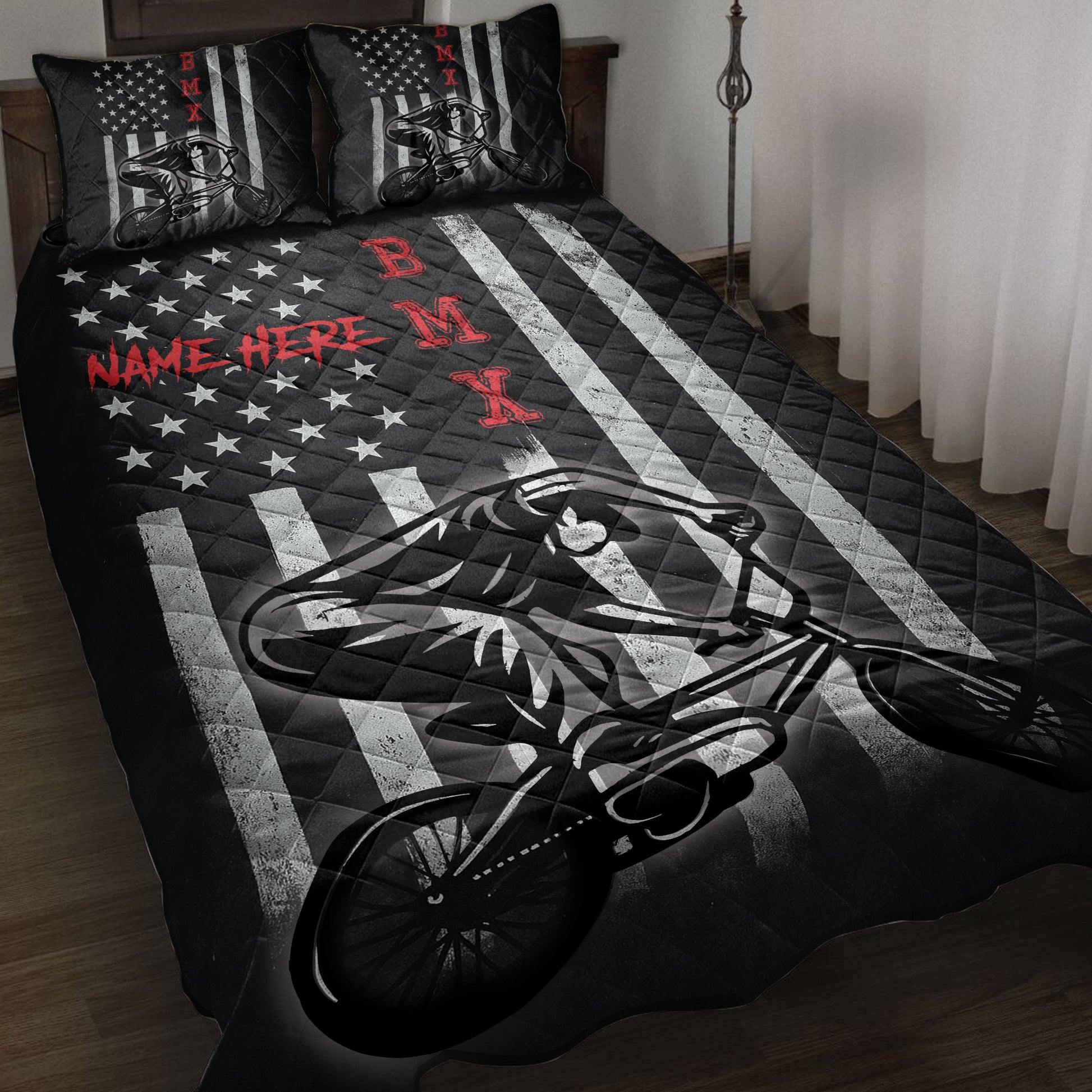 BMX quilt blanket displayed on a bed with bold black, white, red, star, and BMX rider artwork
