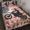 Motocross quilt blanket displayed on a bed with black dirt bike rider artwork, red silhouettes, and blue stars