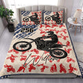 Motocross quilt blanket styled in a bedroom with large dirt bike rider artwork and red riding silhouettes