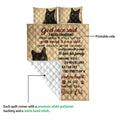 Black cat quilt blanket with printed front and white quilted backing shown in a detail view
