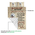 Close view of a Great Pyrenees quilt showing the printed front, white backing, dog portraits, and quilted stitching